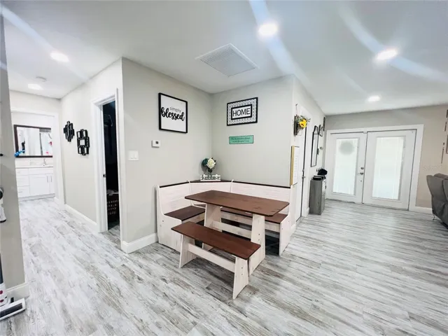 VIEW OF DINING AREA, HALL, AND ENTRANCE FROM KITHEN