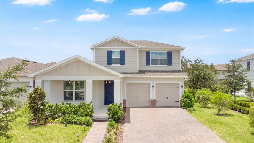 Stunning two-story home with exceptional curb appeal and a beautifully manicured front yard.
