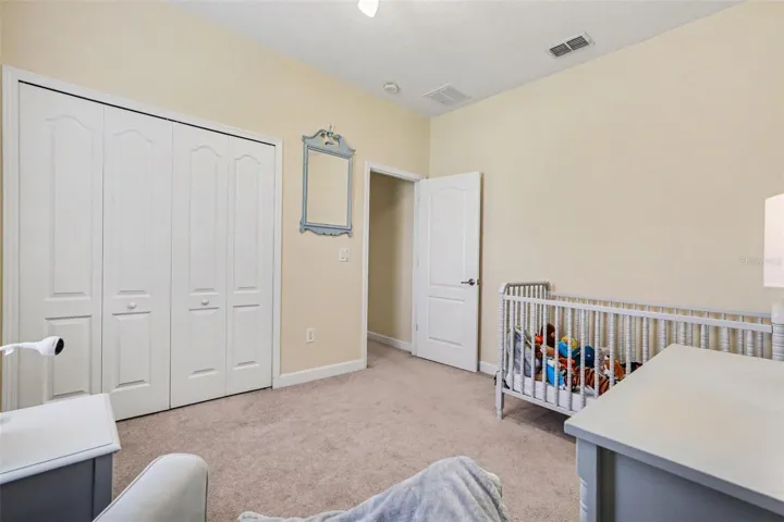 Bedroom 3 showing double closet doors in Tampa FL 33647.