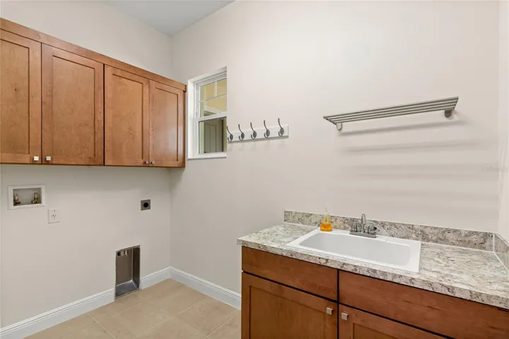 Convenient Inside Laundry Room with sink & lots of cabinets!