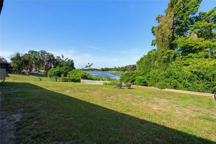 View of the large rear yard overlooking Lake Gandy a 43 acre natural lake