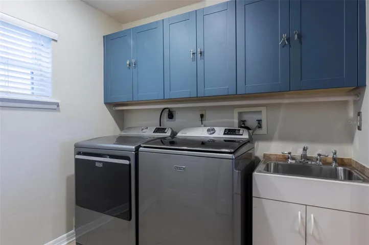 Interior laundry room with W&D hookup, utility sink and pantry - W&D do not convey