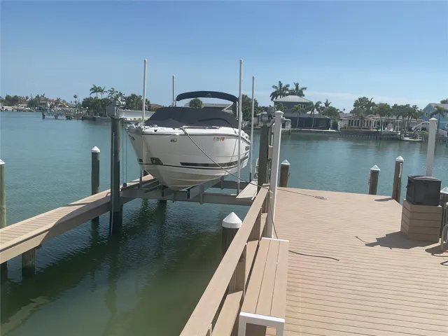Composite deck with 16k lb lift, with wrapped pilings, catwalk, water & electric supply, shower and dockbox