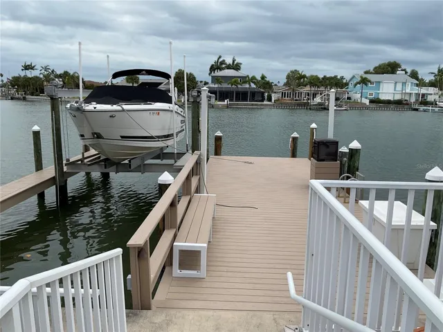 Composite deck with 16k lb lift, with wrapped pilings, catwalk, water & electric supply, shower and dockbox