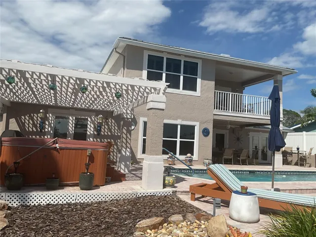 Back of house with hot tub area