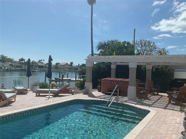 Saltwater heated pool and hot tub with elegant pergola