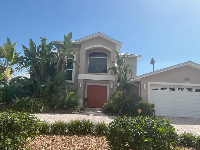 Mature xeriscape landscaping, in front and back, uses eco-friendly recycled water
