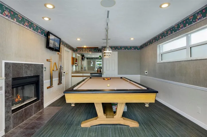 Tournament-sized  (9'x5') Vintage Brunswick Pool Tableand dual-sided gas fireplace