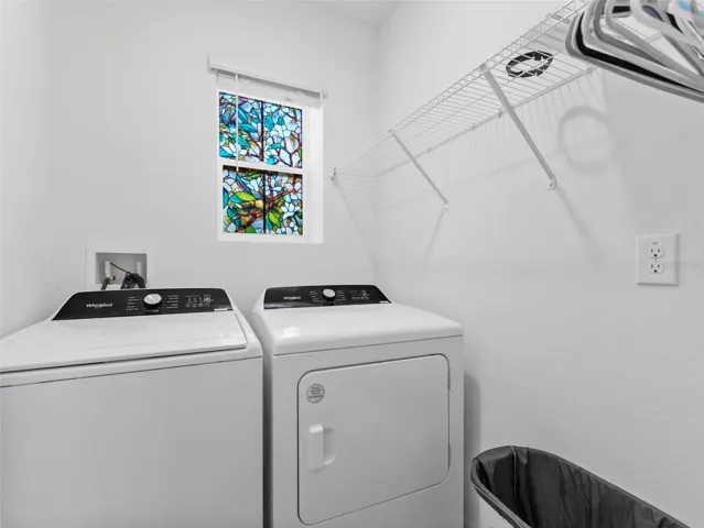 Indoor laundry room on the way to the garage