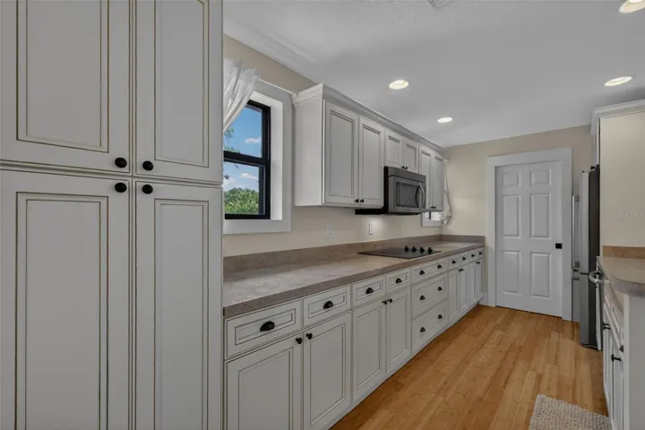 Kitchen with loads of cabinets; w/d closet straight ahead