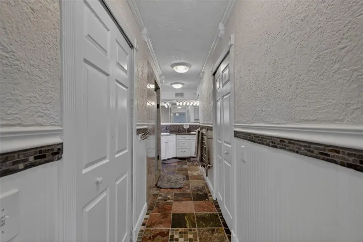 Primary en-suite bathroom with dual walk in closets