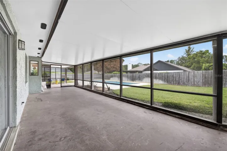 Large Screened Porch overlooking pool and spacious, fenced yard.