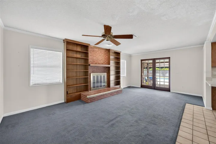 Family room with wood burning fireplace, French doors to open patio