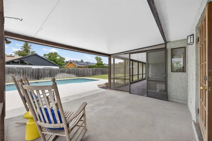 Enjoy outdoor living on the oversized screened porch overlooking the expansive swimming pool and spacious backyard.