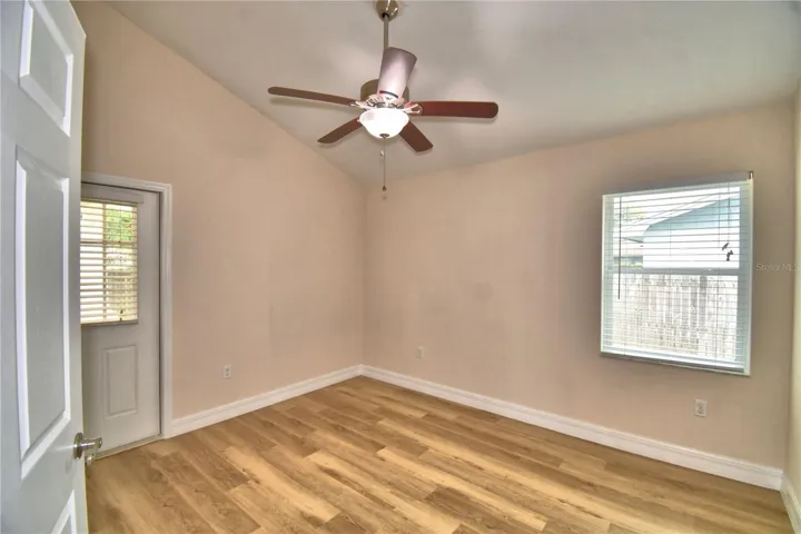 Primary bedroom with door to back porch.