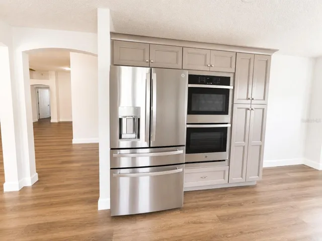 Kitchen with refrigerator and double oven