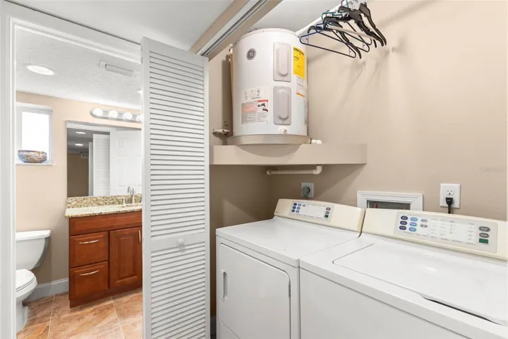 The inside laundry area includes a full-size washer and dryer along with convenient storage space.