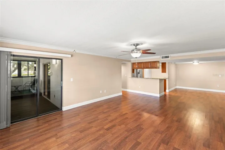 A neutral color palette, wood-look flooring, and an open-concept design create a bright and versatile living space.