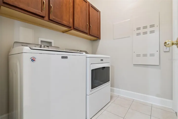 Utility Room w/ a washer, electric dryer, natural gas connection for the future & storage cabinets