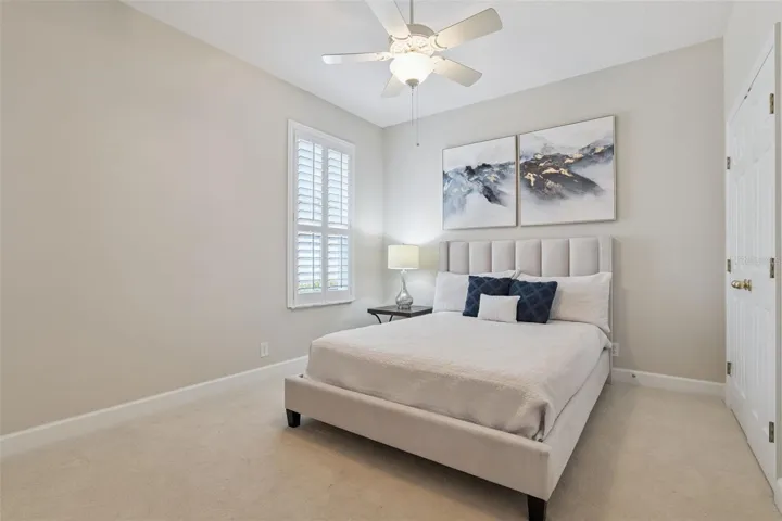 11' x 12' Bedroom #2 w/ Plantation style shutters & a ceiling fan