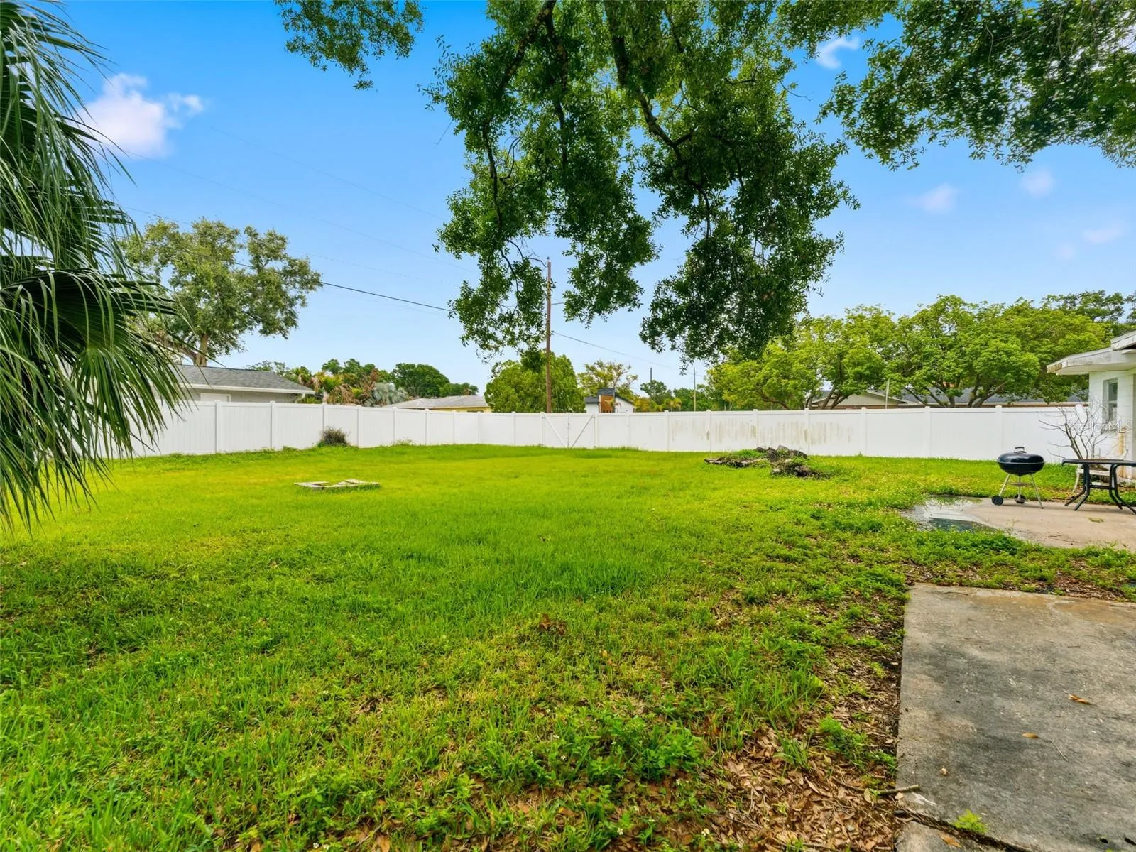 Open backyard with 6' vinyl fence