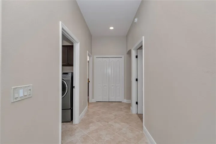 Hallway leading to laundry room and primary bedroom