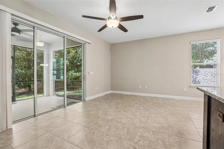 Triple sliding glass doors open up to the screened lanai.