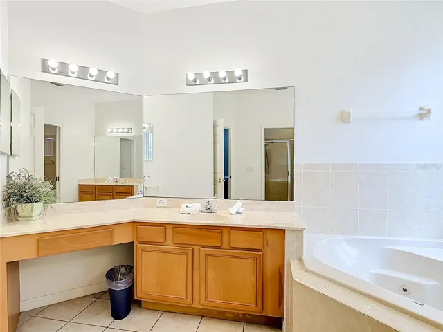 Primary Bathroom with Dual Vanities and Garden Tubh