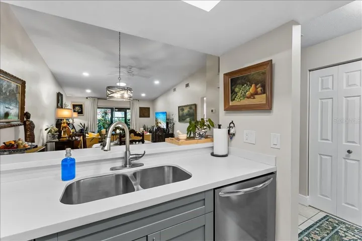 Kitchen features updated cabinetry, double sink, and Corian countertops