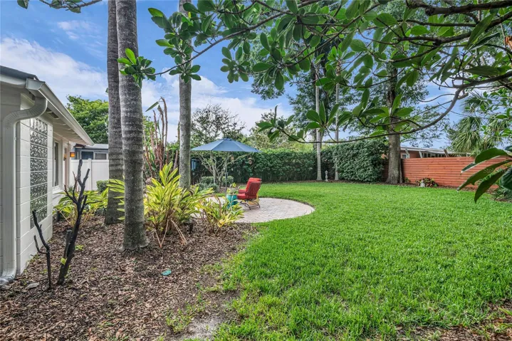 Spacious fenced backyard with paver patio