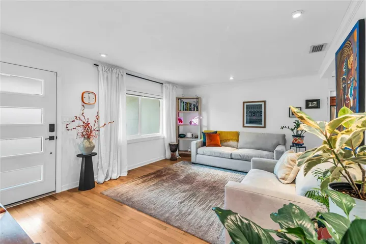 Open floor plan with lots of natural light and beautiful hardwood floors