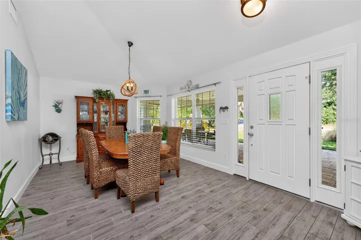The dining room has plank tiled flooring, natural light and is located immediately to the right of the front enterance.