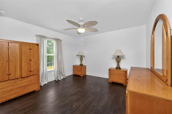 Bedroom 3 features laminate flooring and a ceiling fan.