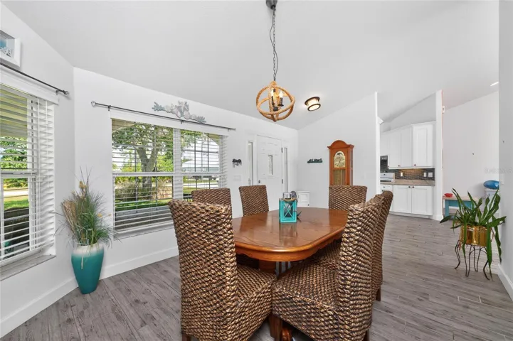 A view of the dinning room looking toward the kitchen &amp; front entryway.