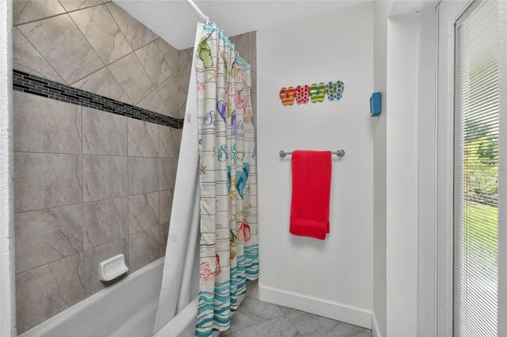 There is a combo tub/shower in the guest bathroom with a convenient door to the lanai.
