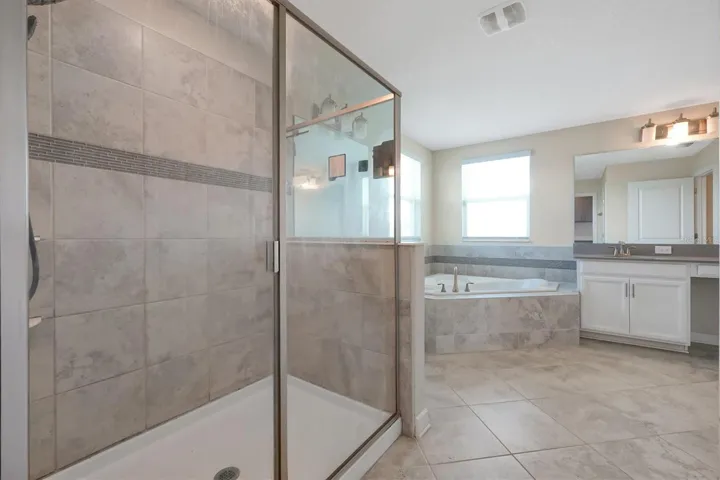 Primary Bathroom w/ dual-sink and plenty of natural lighting - stand up walking shower
