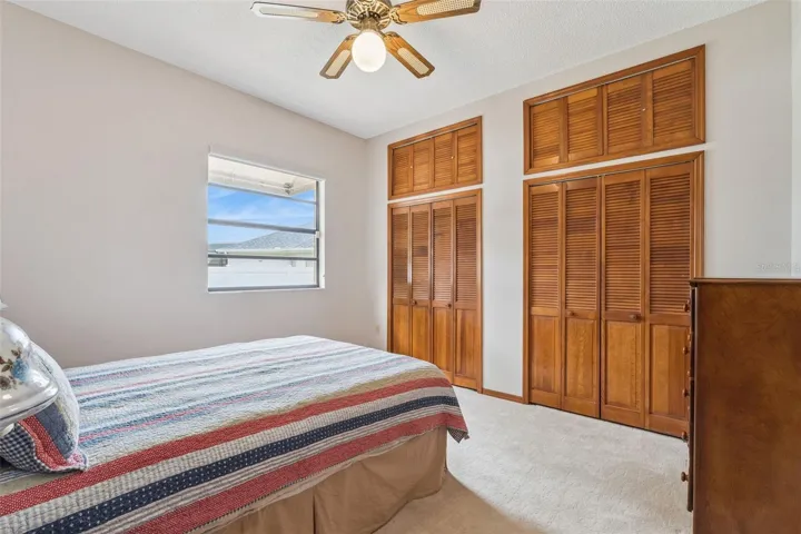 Carpeted Bedroom #1; connected closets with overhead storage.  Private entrance from bedroom to guest bath.  It could easily be used as a mother- or father-in-law suite