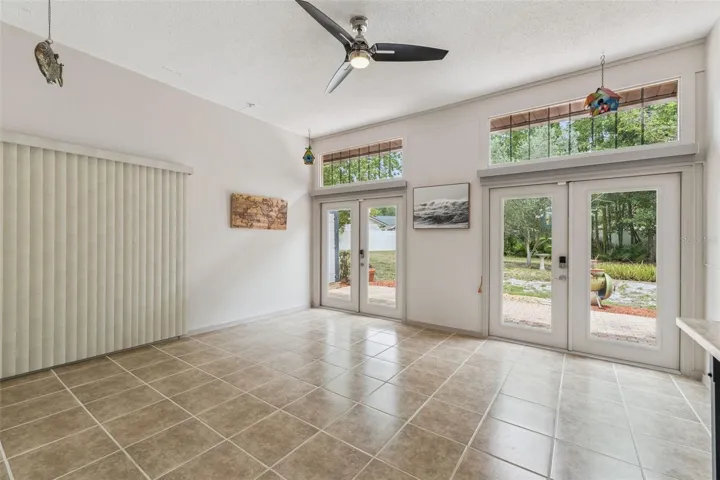 Under-air bonus room. Has kitchen passthrough. Beautiful French doors lead to the over-sized backyard.  Lots of potential!!
