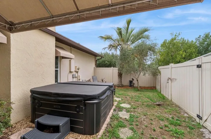 Peaceful and private courtyard off of primary suite complete with a four-person hottub as well as sitting area.