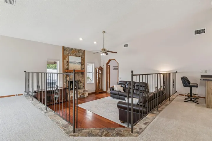 Overlooking the cozy conversation pit and fieldstone fireplace