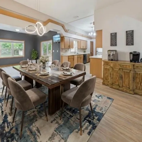 Virtually staged with wall removed between existing eat-in kitchen and existing dining room.
