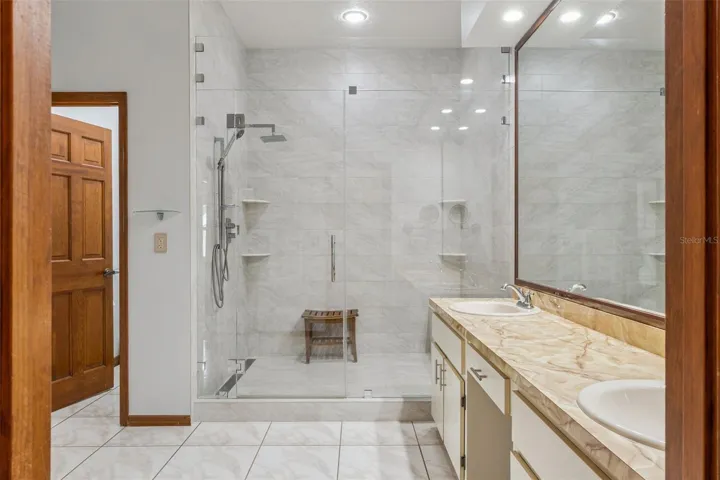 Stunning renovated ensuite spa-like shower with two shower heads (rain and flexible hand-held).  Convenient built-in bench.
