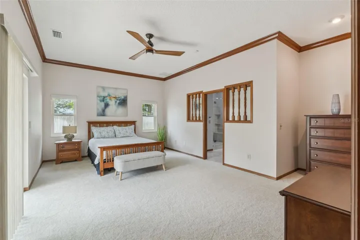 Spacious primary suite; remote-controlled blinds; opens to beautiful courtyard w/spa and sitting area