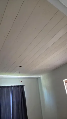 Shiplap ceiling in larger bedroom