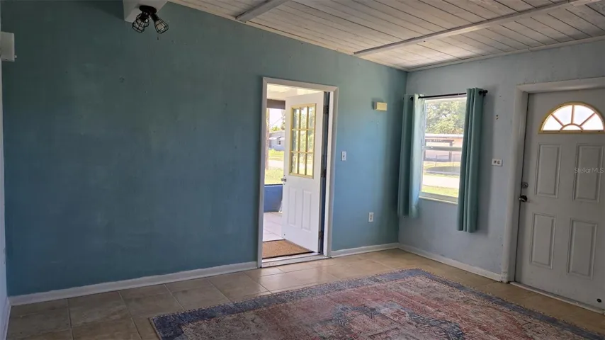 Living Room with entrance to screened in patio
