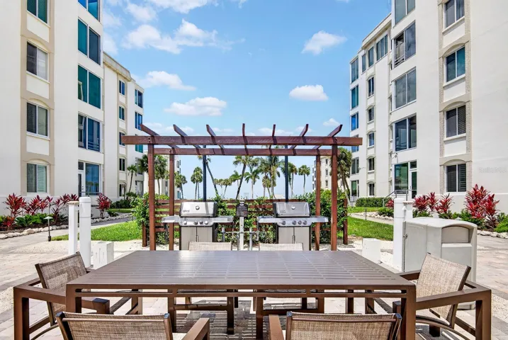 BBQ grill and tables close to buildings.