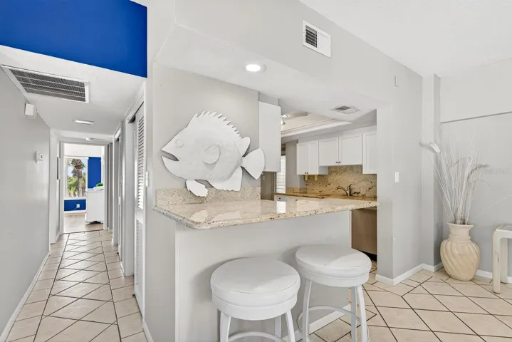 Kitchen, breakfast bar and hallway to bedrooms