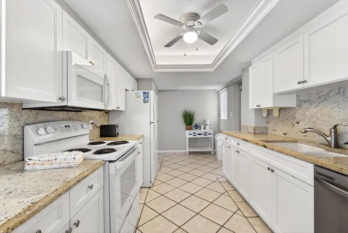 Facing into kitchen from dining area, plenty of cabinets and counter space
