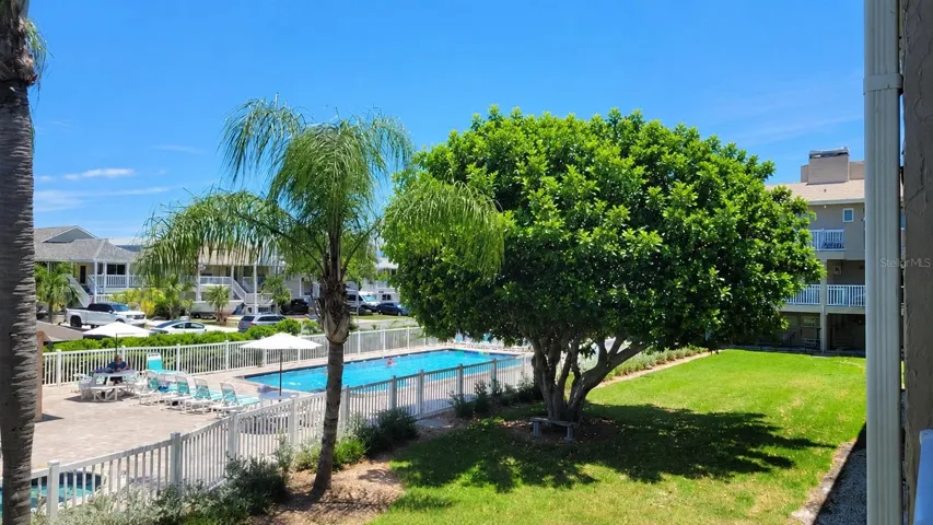 View of the pool and hot tub from balcony area.