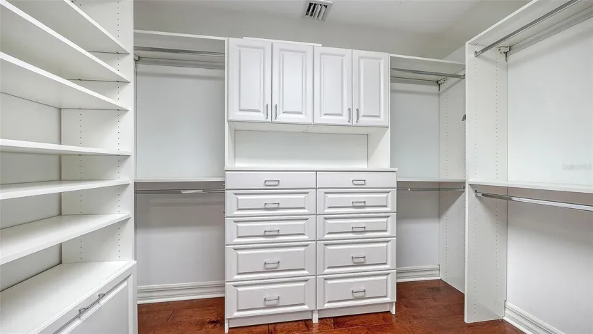 The custom walk-in closet offers exceptional organization and storage.